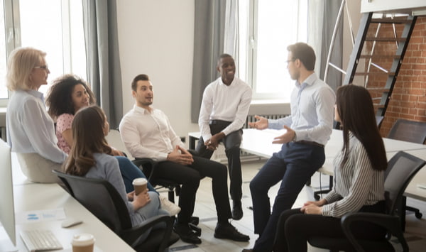 Employees having an informal briefing at workplace