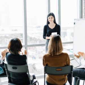 Woman coaching and teaching in modern office