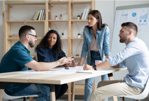 Team leader listening to skilled coworker