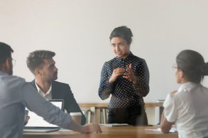 Woman discussing in front of her colleagues