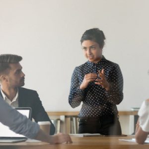 Woman discussing in front of her colleagues