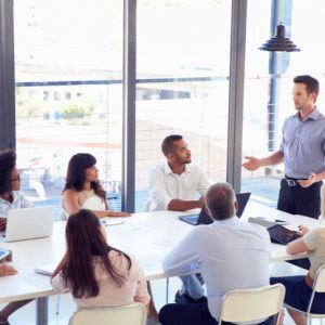 Businessman discussing project to colleagues at a meeting