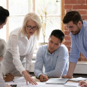 Mature woman teaching her colleagues