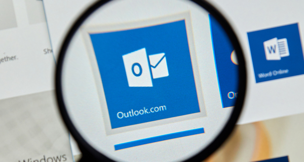 Microsoft Office Outlook on the web under magnifying glass.